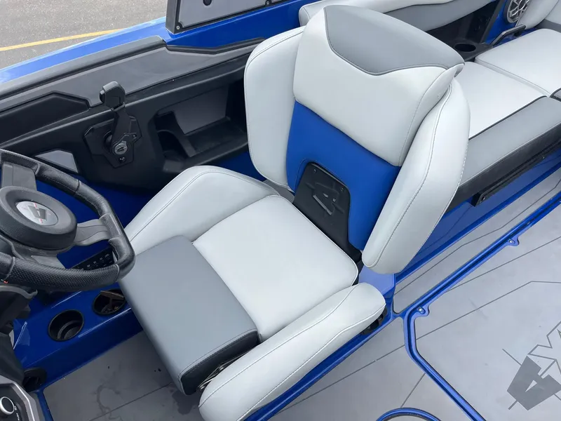 Slide: The Image of 2023 Axis T220 boat interior with blue and gray seating and steering wheel. - 27