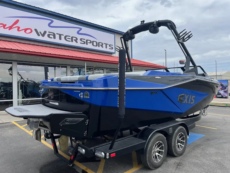 Slide: The Image of 2023 Axis T220 boat in blue and black at Idaho Water Sports dealership. - 4