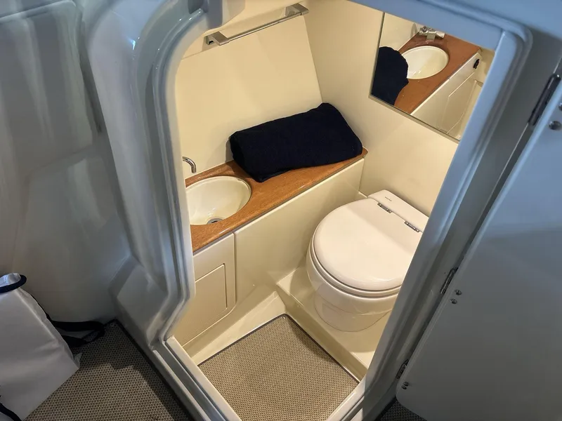 Slide: The Image of 2019 Chris-Craft Launch 28 GT boat bathroom with sink, toilet, and mirror. - 10