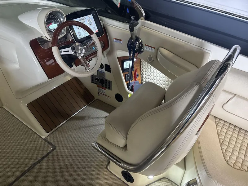 Slide: The Image of Interior of 2019 Chris-Craft Launch 28 GT, featuring steering wheel and dashboard controls. - 11