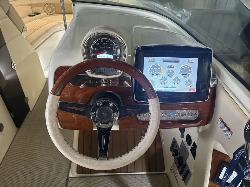 Slide: The Image of 2019 Chris-Craft Launch 28 GT dashboard with steering wheel and digital display. - 12