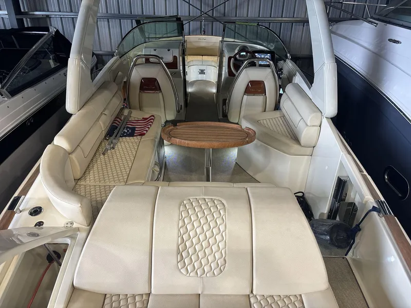 Slide: The Image of 2019 Chris-Craft Launch 28 GT interior with luxurious seating and wooden table. - 6