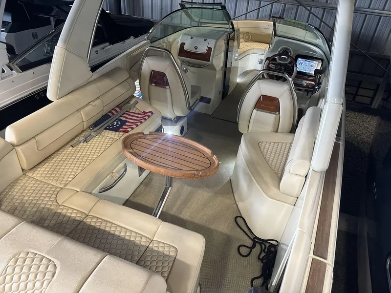 Slide: The Image of 2019 Chris-Craft Launch 28 GT interior with beige seating and wooden table. - 7