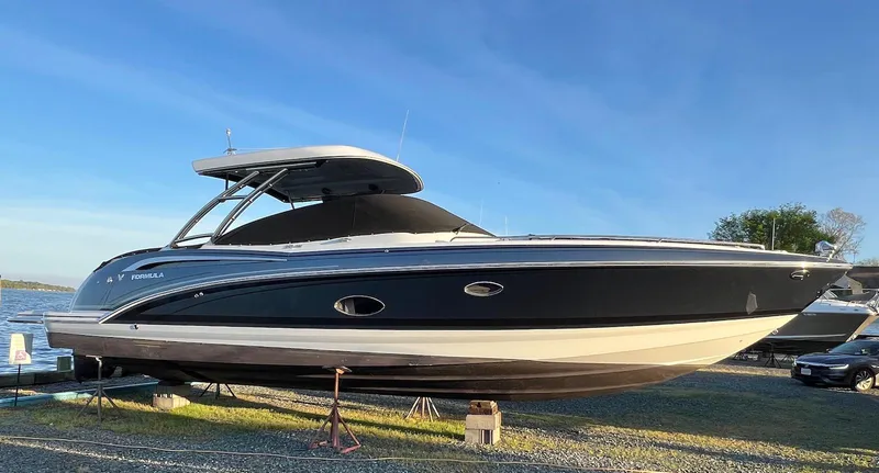 Slide: The Image of 2015 Formula 350 Crossover Bowrider boat on display, side view, outdoors. - 0