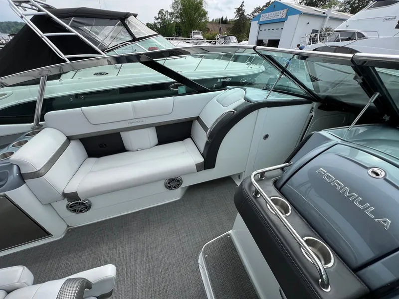 Slide: The Image of 2015 Formula 350 Crossover Bowrider interior with white seating and sleek design. - 12
