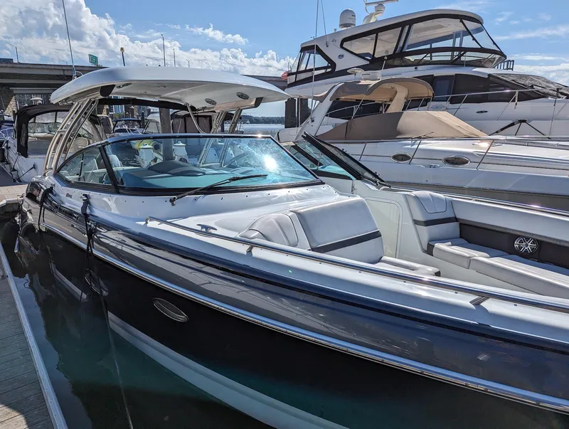 Slide: The Image of 2015 Formula 350 Crossover Bowrider docked, showcasing sleek design and spacious seating. - 2