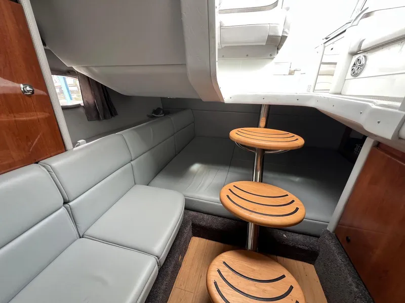 Slide: The Image of 2015 Formula 350 Crossover Bowrider interior with gray seating and wooden steps. - 20