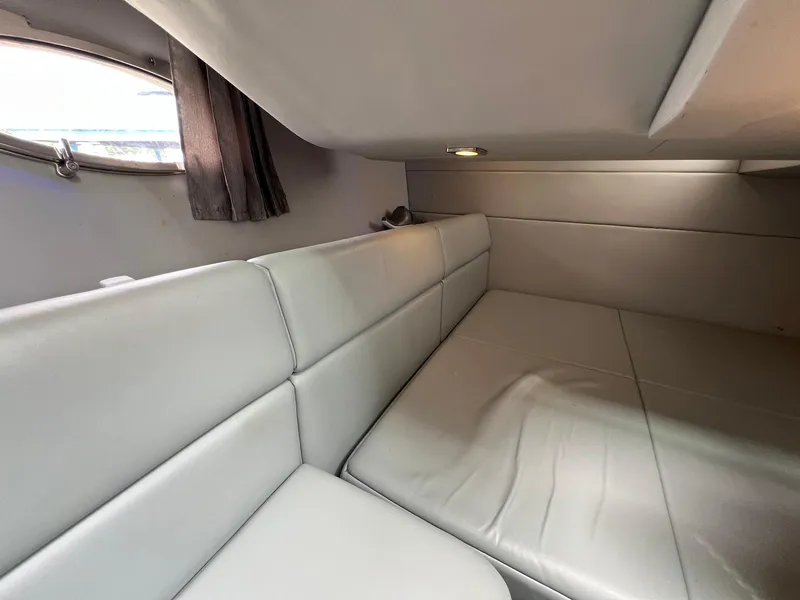 Slide: The Image of 2015 Formula 350 Crossover Bowrider cabin interior with gray seating and window. - 21