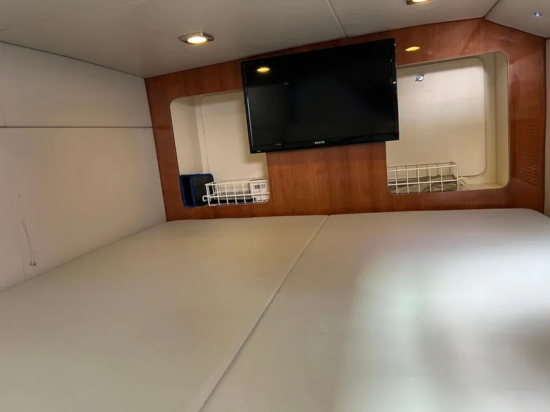 Slide: The Image of 2015 Formula 350 Crossover Bowrider cabin with TV and storage shelves. - 22