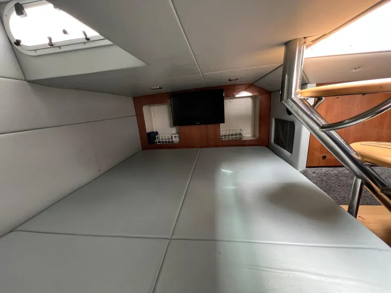 Slide: The Image of 2015 Formula 350 Crossover Bowrider cabin interior with TV and seating area. - 24