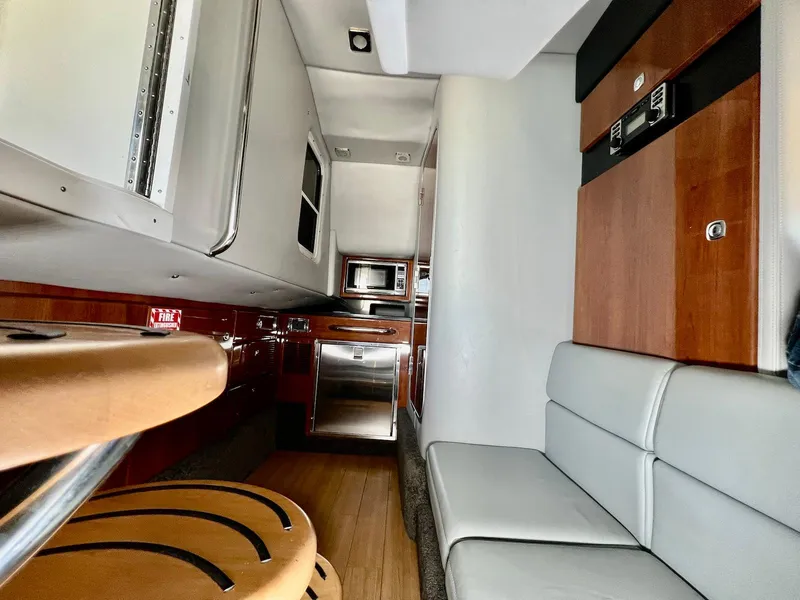 Slide: The Image of 2015 Formula 350 Crossover Bowrider interior with modern kitchen and seating area. - 28