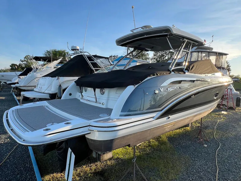 Slide: The Image of 2015 Formula 350 Crossover Bowrider boat on display in a marina setting. - 3
