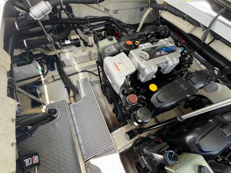 Slide: The Image of Engine compartment of a 2015 Formula 350 Crossover Bowrider, showcasing mechanical components and layout. - 34