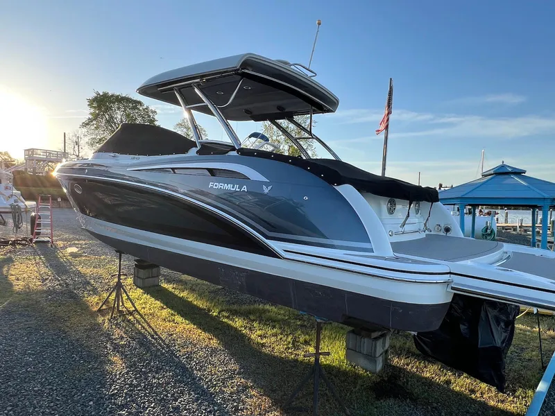 Slide: The Image of 2015 Formula 350 Crossover Bowrider boat on display at a marina during sunset. - 4
