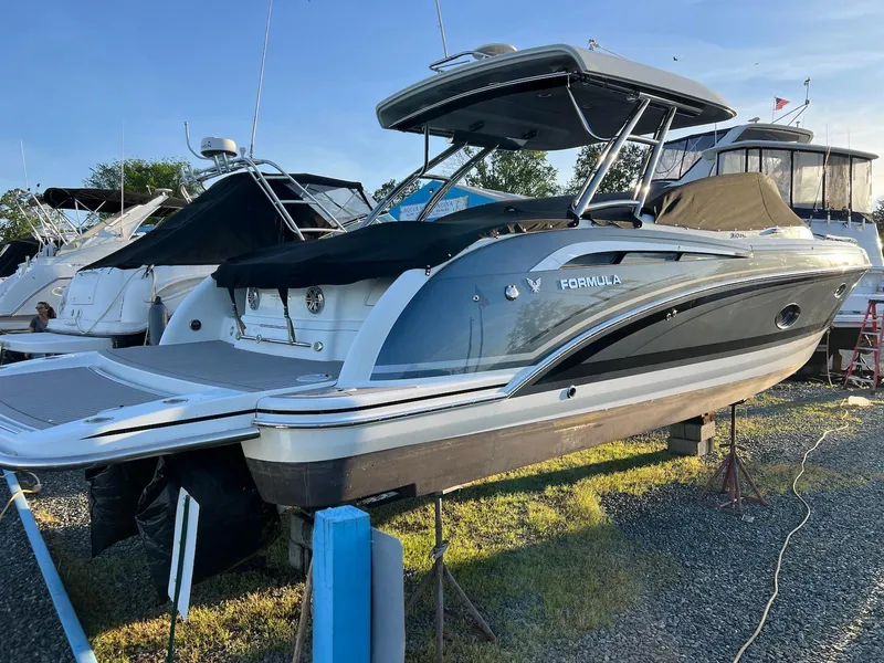 Slide: The Image of 2015 Formula 350 Crossover Bowrider boat on display in a marina setting. - 5