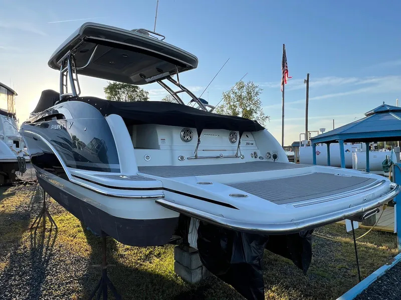 Slide: The Image of 2015 Formula 350 Crossover Bowrider boat on display, rear view with American flag in background. - 6