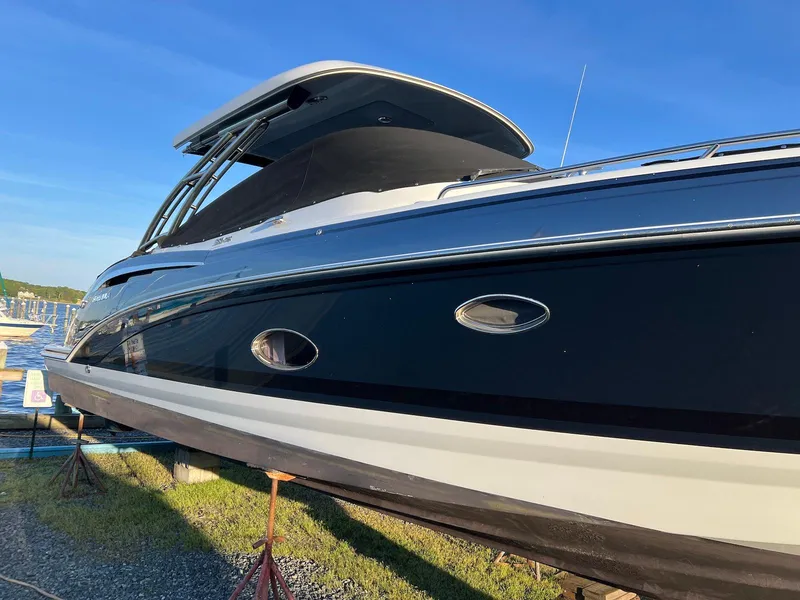 Slide: The Image of 2015 Formula 350 Crossover Bowrider boat on display, sleek design, blue sky background. - 7