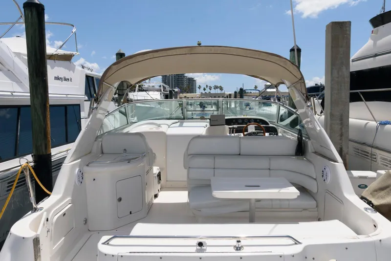 Slide: The Image of 1997 Sea Ray 330 Sundancer cockpit with blue and white seating, steering wheel, and control panel. - 1