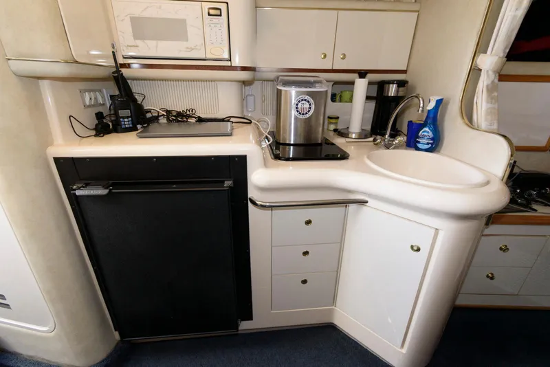 Slide: The Image of Interior of 1998 Sea Ray 330 Sundancer with cozy seating and table. - 10