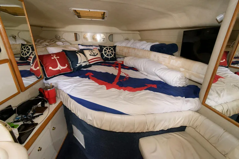 Slide: The Image of 1998 Sea Ray 330 Sundancer kitchen with microwave, sink, and storage cabinets. - 11