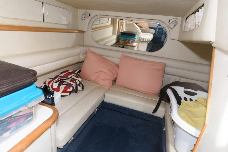 Slide: The Image of Interior of 1998 Sea Ray 330 Sundancer with nautical-themed bedding and pillows. - 13