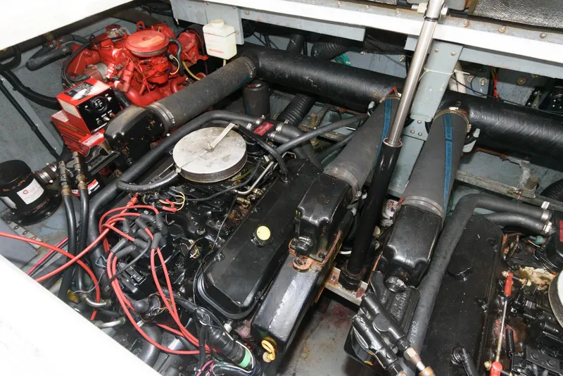Slide: The Image of Engine compartment of a 1998 Sea Ray 330 Sundancer boat, showcasing dual engines and components. - 16