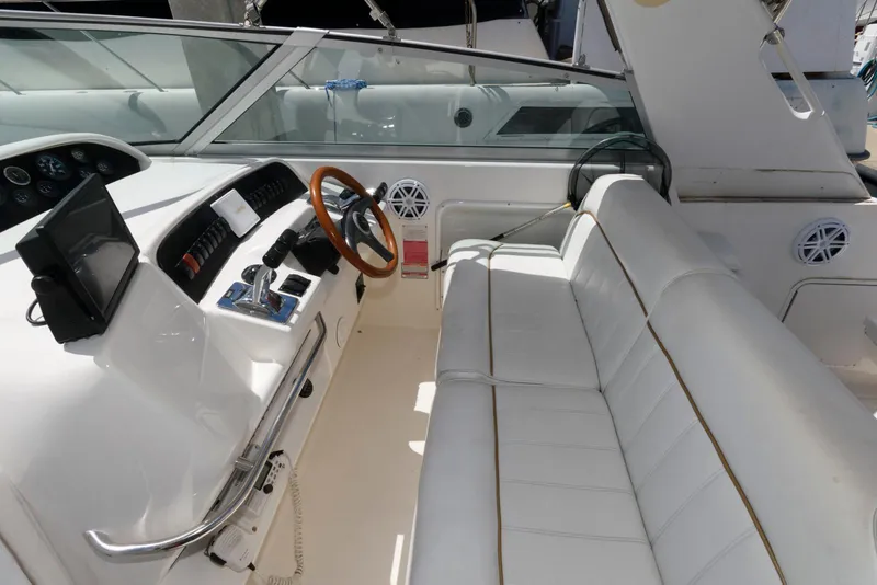 Slide: The Image of 1998 Sea Ray 330 Sundancer helm with wooden steering wheel and control panel. - 4