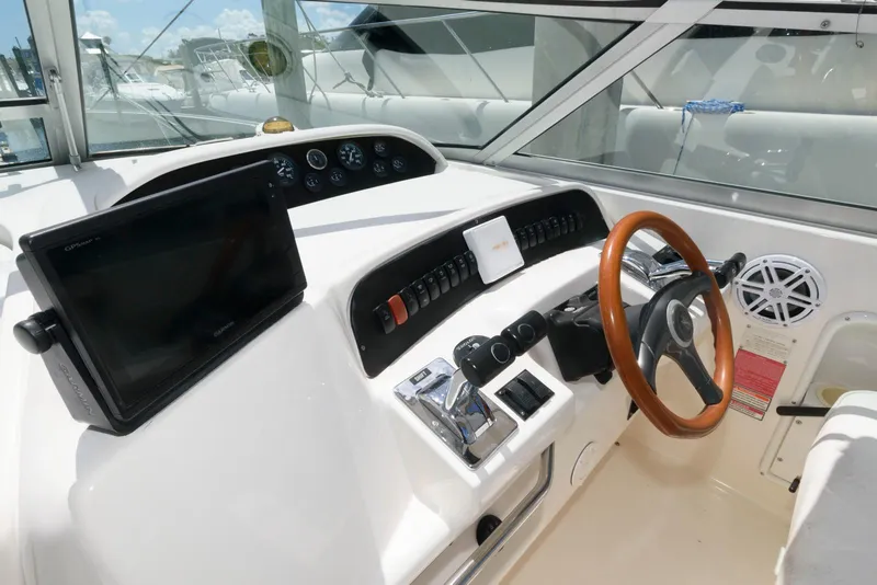 Slide: The Image of 1997 Sea Ray 330 Sundancer boat seating area with American flag. - 5