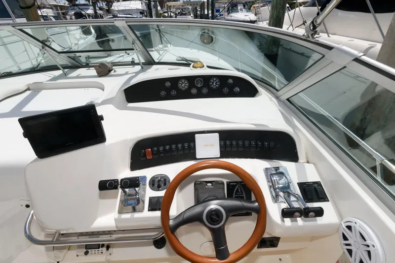 Slide: The Image of 1997 Sea Ray 330 Sundancer boat interior with sink and seating area. - 6