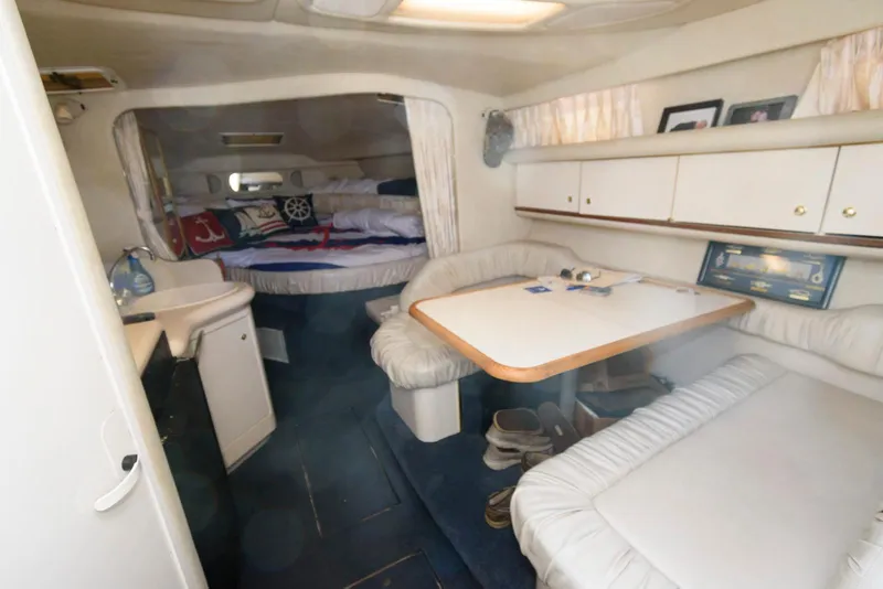 Slide: The Image of 1998 Sea Ray 330 Sundancer docked, showcasing sleek design and comfortable seating. - 8
