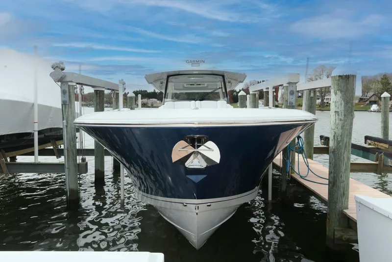 Slide: The Image of 2022 Pursuit S 378 Sport boat docked, showcasing sleek design and modern features. - 1