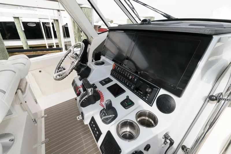 Slide: The Image of 2022 Pursuit S 378 Sport boat dashboard with advanced controls and navigation screens. - 11