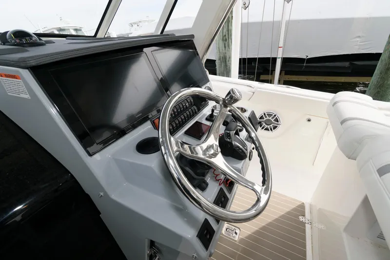 Slide: The Image of 2022 Pursuit S 378 Sport boat helm with modern controls and steering wheel. - 12