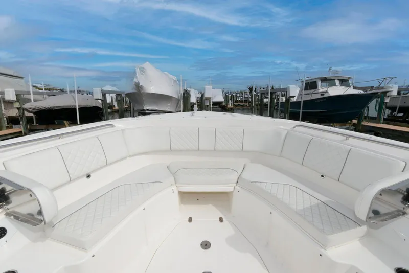 Slide: The Image of 2022 Pursuit S 378 Sport boat with spacious seating, docked under a clear blue sky. - 16