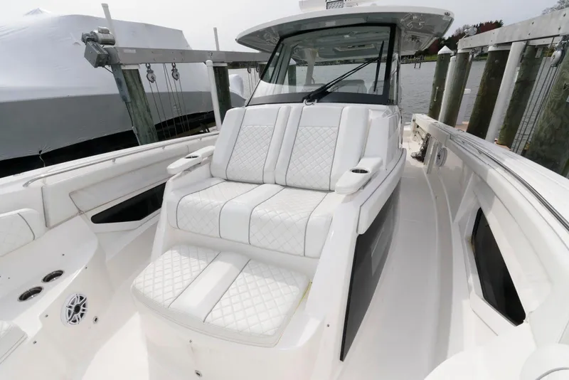 Slide: The Image of 2022 Pursuit S 378 Sport boat with luxurious white seating and sleek design. - 17