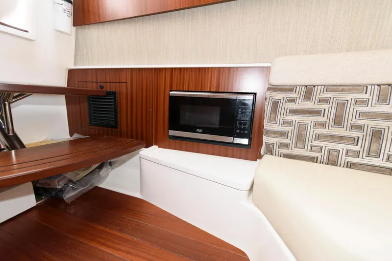 Slide: The Image of 2022 Pursuit S 378 Sport interior with microwave and wooden accents. - 25