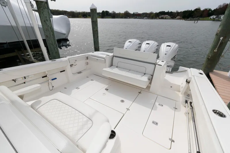 Slide: The Image of 2022 Pursuit S 378 Sport boat with spacious deck and triple outboard engines. - 8