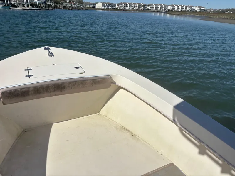 Slide: The Image of 2005 Jones Brothers 18 Cape Fisherman boat on calm water near shoreline. - 10