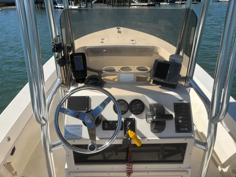 Slide: The Image of 2005 Jones Brothers 18 Cape Fisherman boat dashboard with steering wheel and navigation equipment. - 11