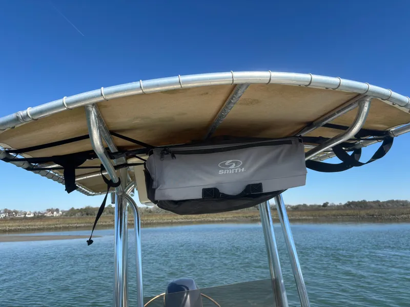 Slide: The Image of 2005 Jones Brothers 18 Cape Fisherman boat with T-top and storage bag on calm water. - 15