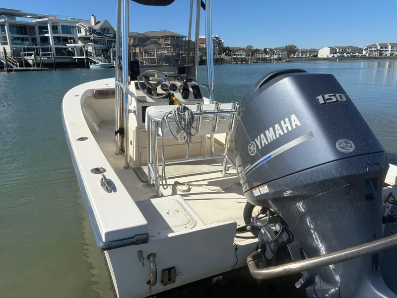 Slide: The Image of 2005 Jones Brothers 18 Cape Fisherman boat with Yamaha 150 engine docked by waterfront homes. - 16