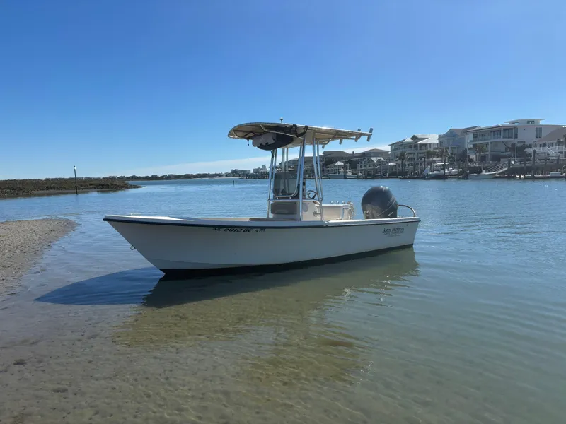 Slide: The Image of Jones Brothers 18 Cape Fisherman boat, 2005 model, docked in calm waters near shoreline. - 3