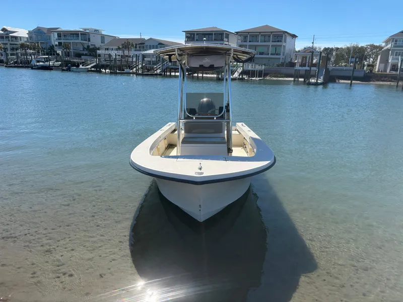 Slide: The Image of 2005 Jones Brothers 18 Cape Fisherman boat docked in calm waters near residential area. - 5
