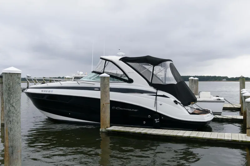 Slide: The Image of 2014 Crownline 294 CR boat docked on a cloudy day. - 1