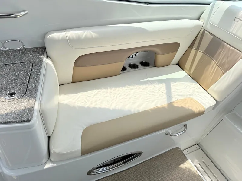 Slide: The Image of 2014 Crownline 294 CR boat interior with beige and white seating. - 10
