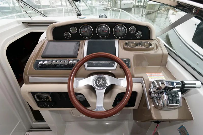 Slide: The Image of 2014 Crownline 294 CR boat dashboard with steering wheel and control panel. - 12