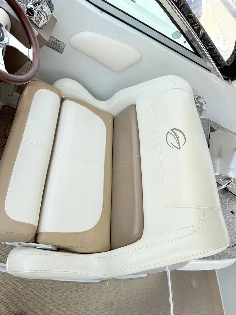 Slide: The Image of 2014 Crownline 294 CR boat seat with beige and white upholstery. - 13