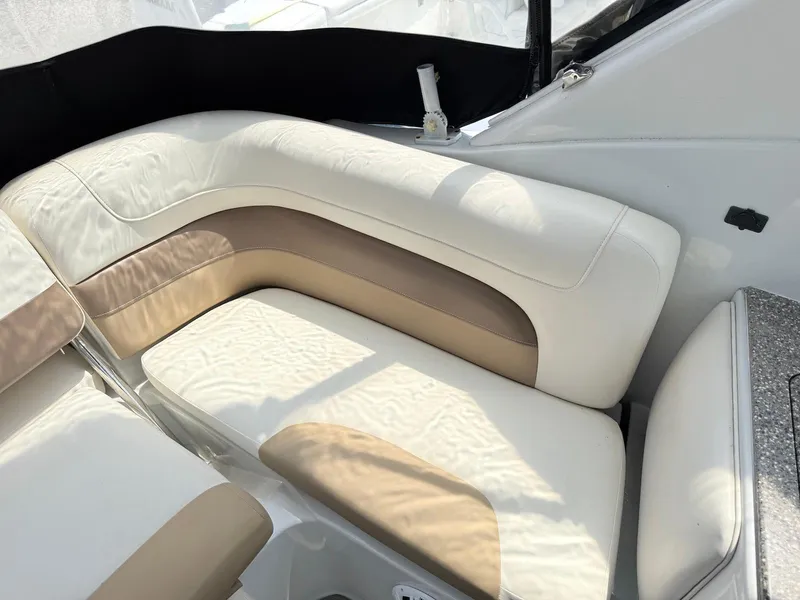 Slide: The Image of 2014 Crownline 294 CR boat interior with beige and white seating. - 14
