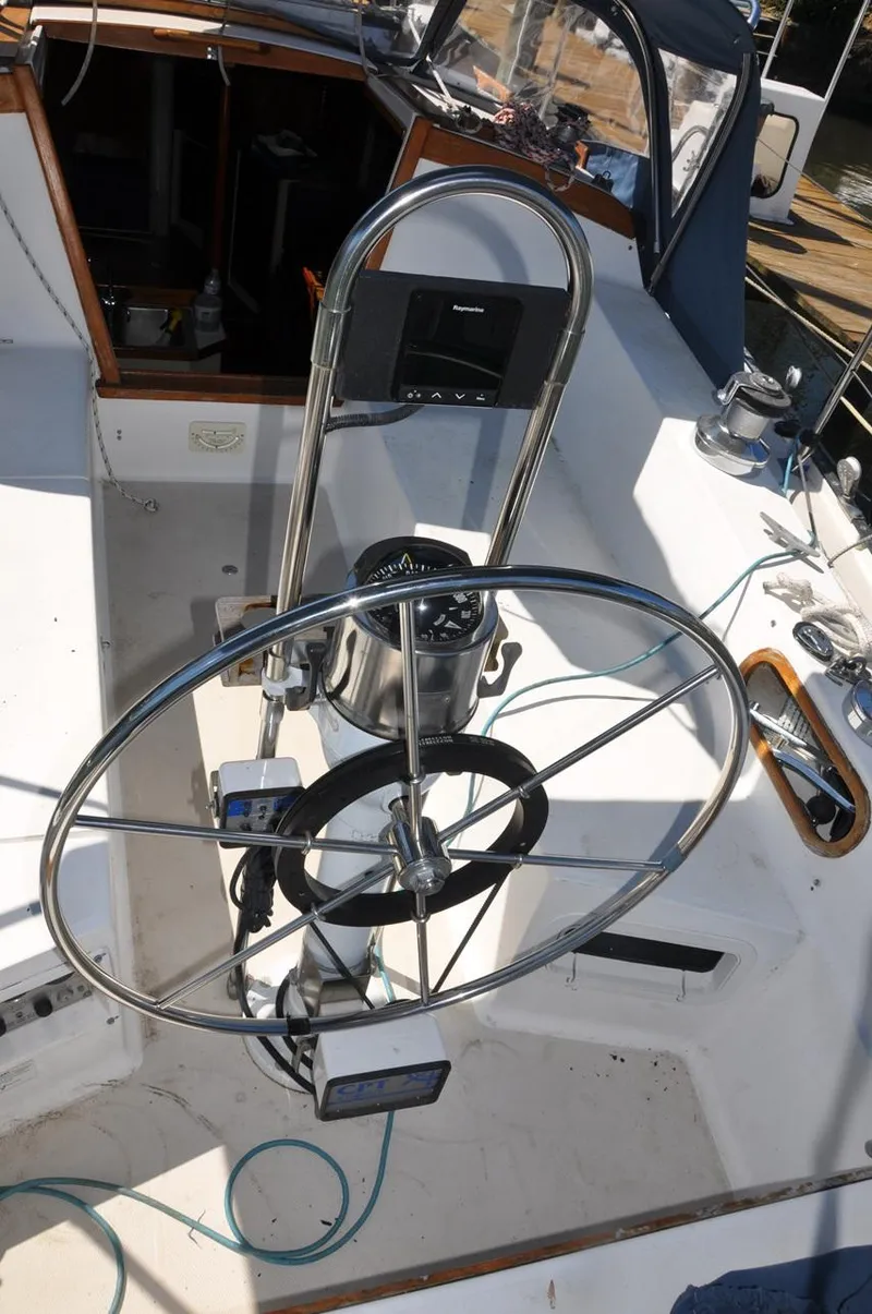 Slide: The Image of 1987 Catalina 36 Tall Rig sailboat cockpit with steering wheel and navigation instruments. - 10