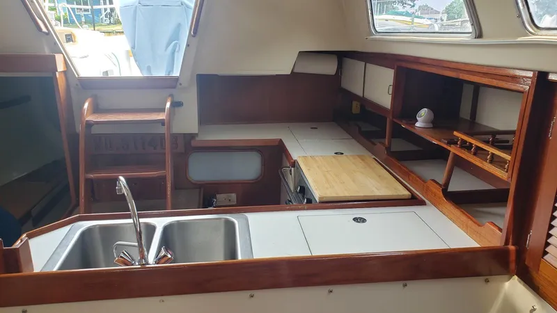 Slide: The Image of Interior of 1987 Catalina 36 Tall Rig sailboat, featuring a compact kitchen area. - 16